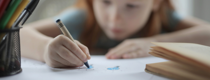 Child drawing on a paper