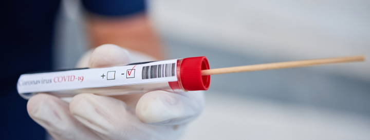 Doctor holding a covid-19 swab test