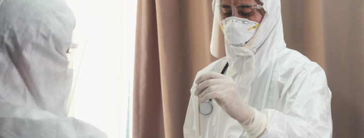 Doctors wearing disposable coveralls