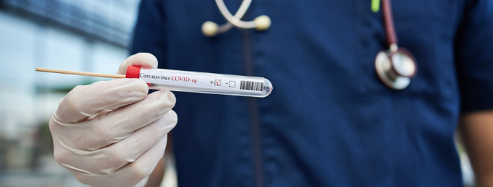 Epidemiologist holding a covid-19 swab test