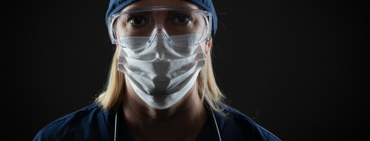 Female NHS worker wearing PPE