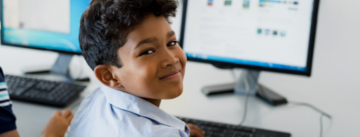 Kid using a computer at school