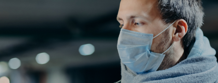 Man wearing surgical mask outdoors