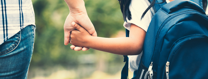 Mother holding daughter's hand