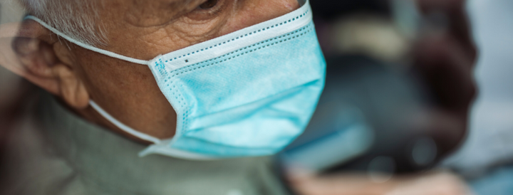 Old man traveling with a mask