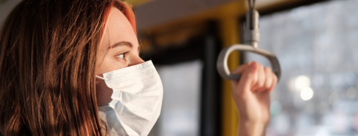 Commuter wearing a face mask in public transportation