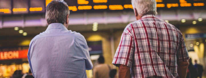 Two passengers standing in an airport