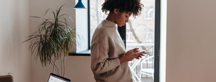 Woman using her phone in an office