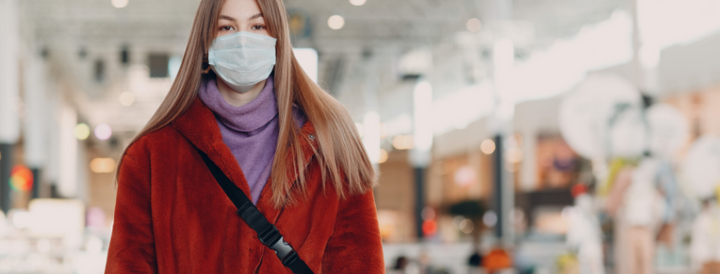 Woman wearing a surgical mask indoors